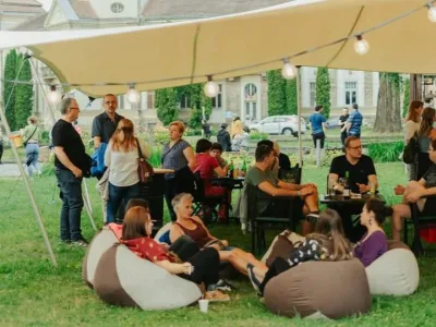 Cozy small event tent to rent withguests sitting comfortably on the beanbags.