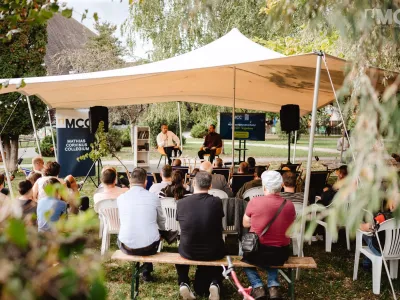 A stretch tent set up at a Summer University in Transylvania, providing a shaded space for attendees.