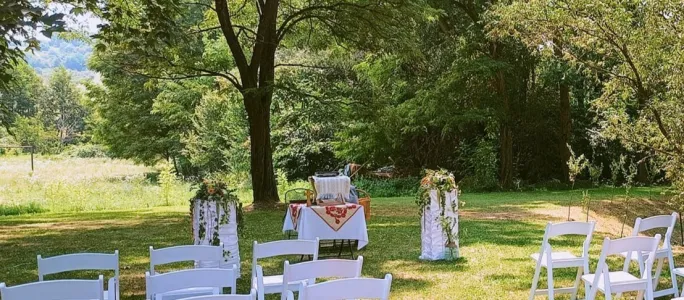 Ceremonie în aer liber cu scaune albe inchiriate